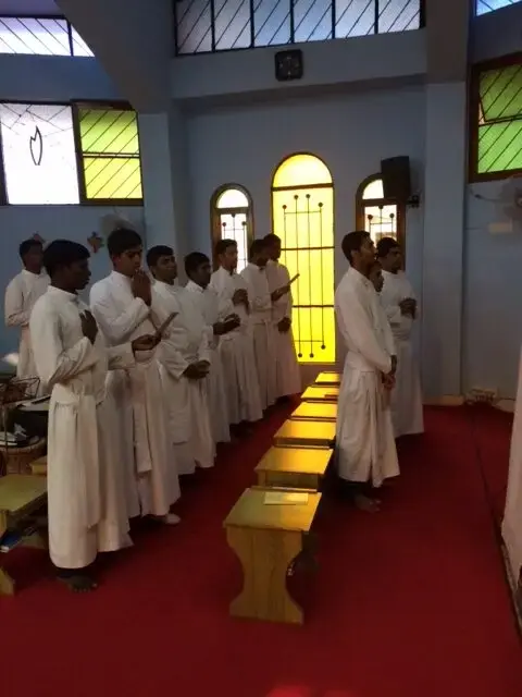 Seminarians in white in the chapel